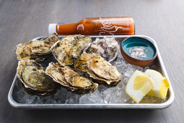 Morro Bay Oyster Company Pacific Golds. Served with House Made Mignonette, Lemon and Hot Sauce