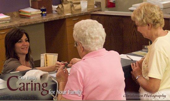 two women checking in for their appointments at the clinic reception desk