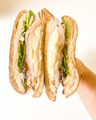 Aww Brie - Turkey, Brie Cheese, Jam, arugula, garlic aioli on a Brioche Bun