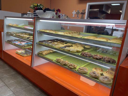 Front counter with donuts and sandwiches on display.