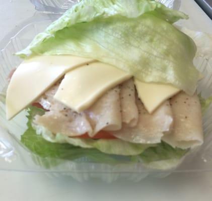 Low Carb Sandwich with turkey, cheese, tomato, onion, pickle, jalapeño, and lettuce wrap