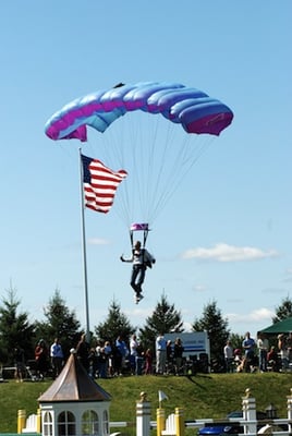 skydiver bringing in the flag during the National Anthem