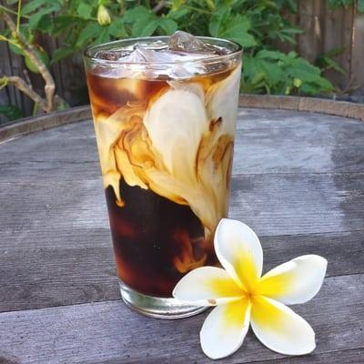 Cold brew coffee over ice with a dash of cream