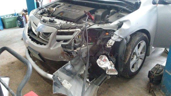 Before photo of a wrecked Toyota Corolla that we repaired recently.