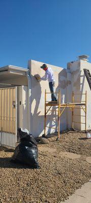 Exterior stucco repair and repaint.