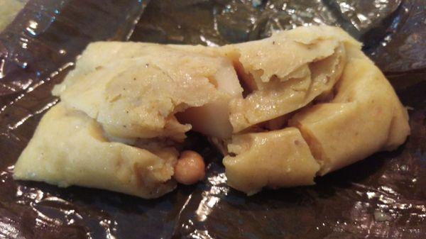 Tamal de Pollo: Savory corn dough filled with chicken, potato, & chick peas, wrapped in banana leaf