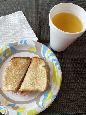 Ham, egg, and cheese sandwich on toast with OJ