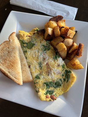 Three Egg Omelette with Bacon, Spinach, and American Cheese. Served with toast and home fries