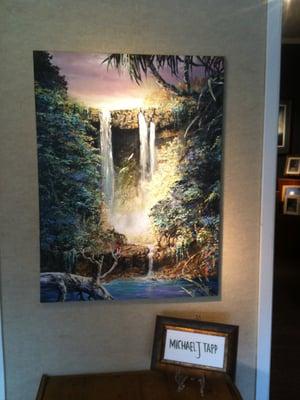 An example of local Kapa'a artist, Michael Tapp's art. This piece is an original oil on canvas of the Wailua Waterfalls.