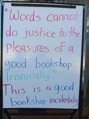 White board sign outside Dogwood Books.