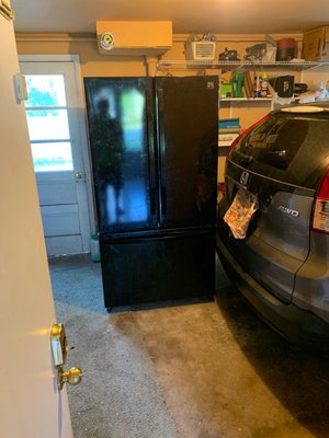 Two year old Kenmore French Door bottom freezer. In garage with other junk