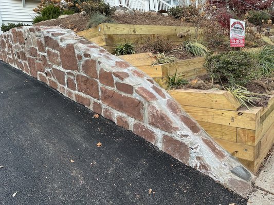 Rock wall, tiered garden, and asphalt paving done by Garcia and Brothers