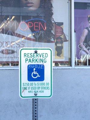 Gang Sign/tags illegally spray painted on their parking lot sign.