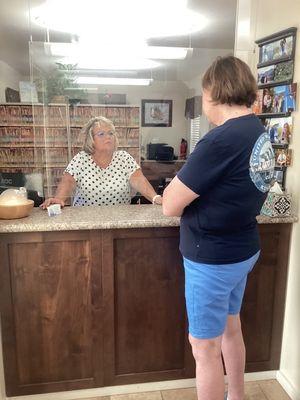 My wife talking with the happiest receptionist in the world!