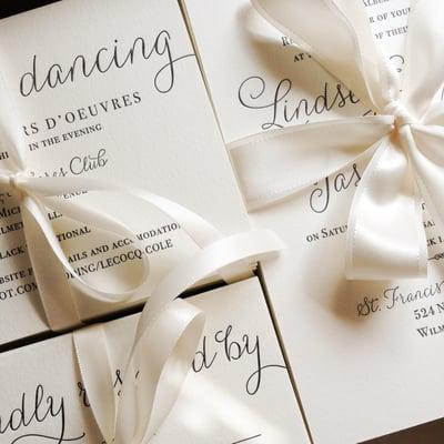 Letterpress wedding invitations all wrapped up with ribbon