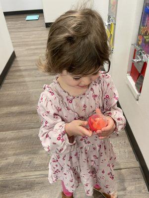 Getting the toy from the vending machine