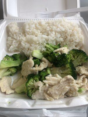 Steamed chicken and broccoli with steamed rice.