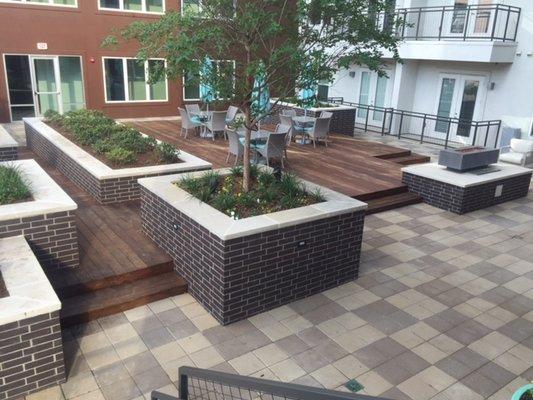 Ipe deck installed around planters for a commercial property.