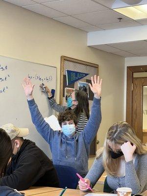 A teacher being photobombed by a student