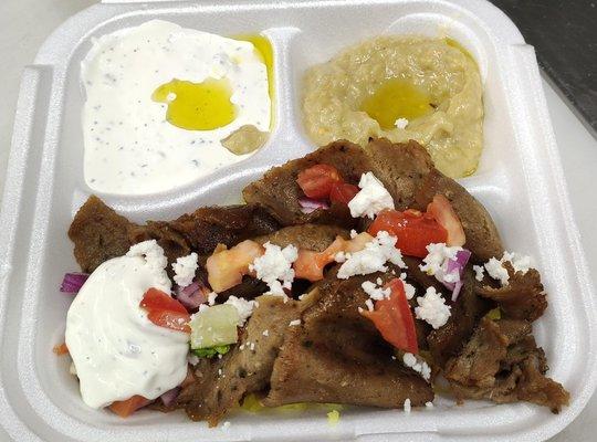 gyro plate! Perfectly spiced gyro meat, creamy hummus, tangy tzatziki, and fluffy rice come together for a flavor explosion in every bite.