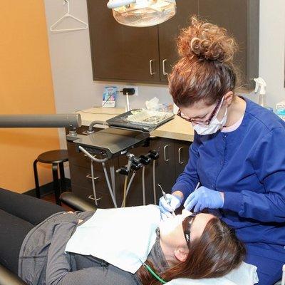 Dental hygienist at Lincoln Center Dental with root canal patient