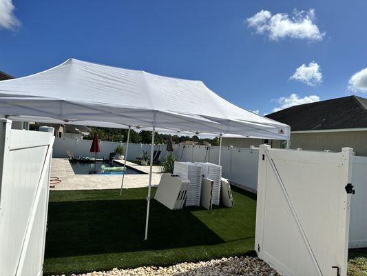 Backyard event by the pool. Tables, tents and chairs.