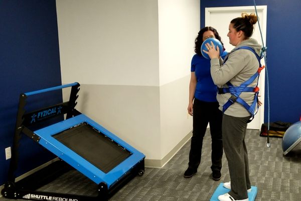 Balance exercise using rebounder in Safety Overhead Support harness