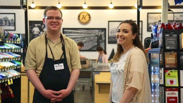 This picture shows a Productive Alternatives client and his coworker smiling for the camera at their workplace