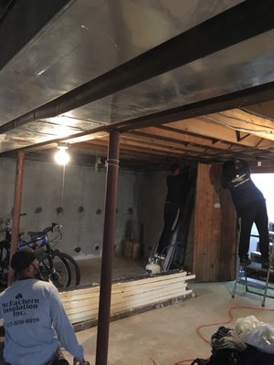 Floor joist insulation work being done