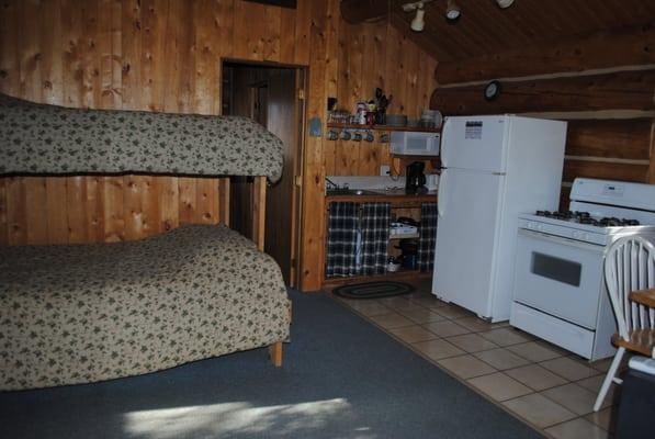 this cabin also has a bedroom though the doorway visible