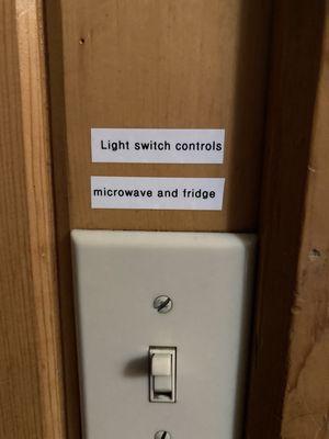 Sign inside. This means light must stay ON if you want the fridge or microwave to work!