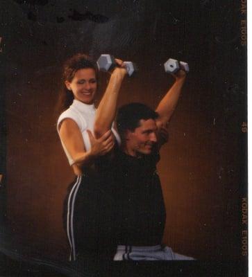 Spotting a clients shoulder press.