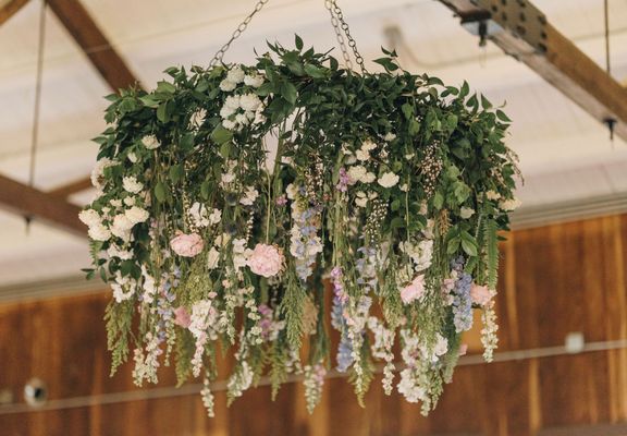 Ceiling hoop install with greenery & draping floral above the dance floor at Parker Mill