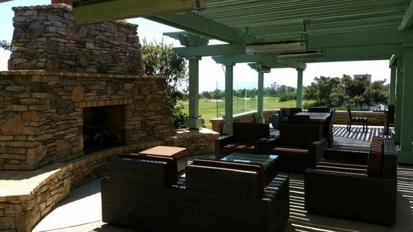 Shaded patio with a view of the course and ocean