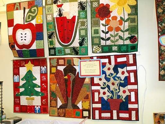 Seasonal wall hangings from the book, Kim Shaefer's Calendar Quilts. Total of twelve.