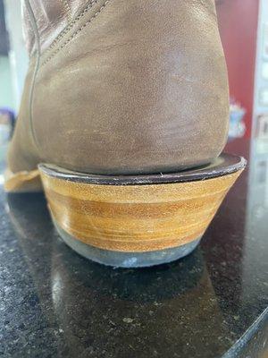 Lifting heel cap on left boot.