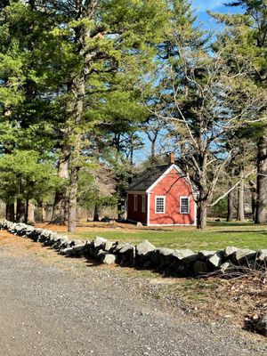 The Schoolhouse is next door. Green Grass, Trees The Road & glacier rocks @ Martha Mary Chapel @ Longfellow's Wayside Inn Sudbury MA.