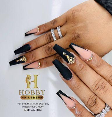 Make a statement with our bold black nails adorned with sparkling rhinestones.