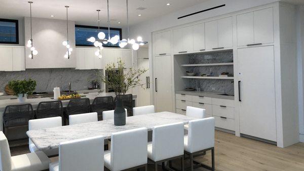 Chic White Kitchen with flat doors and oil rubbed hardware, located in Santa Monica