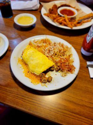 Omelet, hashbrowns, sampler in the background.