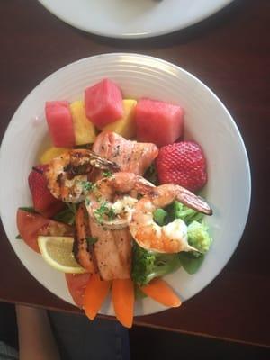 Grilled Alaska salmon and prawns on a bed of greens with fresh fruit.  Wow!