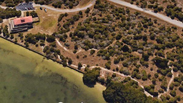 Aerial view of coastline and nature trail.