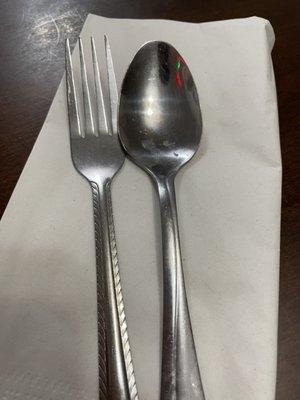 Silverware that was set out on the table in preparation for dinner.