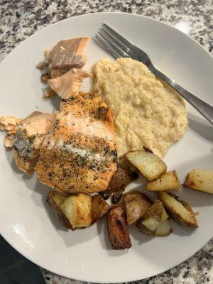 Salmon, potatoes with onions , and grits.