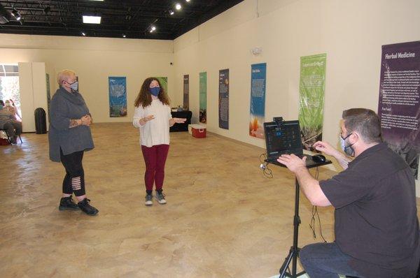 Crystal Melton (left) and Elisabeth Avelar introduce the "Scientific Discoveries" Exhibit as part of the 16th Annual NAS Week.