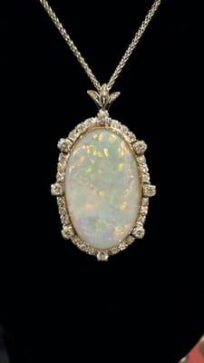 Rare black Opal, diamond, platinum and 18k yellow gold pendant with a French motif.