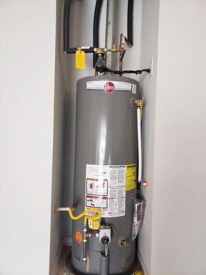 Water heater in an alcove in the Garage with a circulation pump.