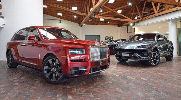 Rolls Royce Cullinan and Lamborghini Urus on showroom floor