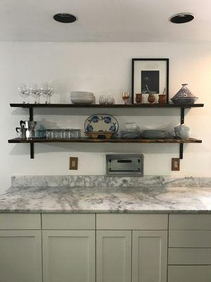 Custom live edge walnut shelves for a kitchen.