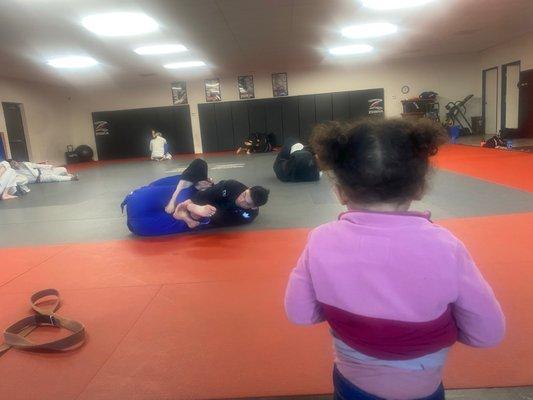 Kid watching BJJ rounds.